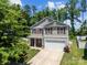Charming two-story home with red shutters, lush landscaping and an inviting covered porch, perfect for relaxing evenings at 5009 Granite Creek Ln, Charlotte, NC 28269