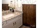 Elegant bathroom featuring granite countertop, white sink, decorative wallpaper, and wooden wainscoting at 5332 Pembrey Dr, Denver, NC 28037
