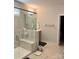 Bright bathroom featuring a walk-in glass shower with marble-like tiled walls and flooring at 5332 Pembrey Dr, Denver, NC 28037