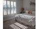 Comfortable bedroom with a white bed frame, accent decor, and shuttered windows at 5332 Pembrey Dr, Denver, NC 28037