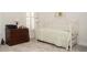 Neutral bedroom showcasing a daybed, dresser, and natural light from the window at 5332 Pembrey Dr, Denver, NC 28037