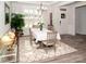 Bright dining room featuring a window with shutters, modern light fixture, and neutral decor at 5332 Pembrey Dr, Denver, NC 28037