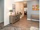 Inviting hallway with a decorative table, bench, and stylish artwork leading to the living spaces at 5332 Pembrey Dr, Denver, NC 28037