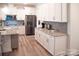 Modern kitchen with white cabinets, stainless steel appliances, and granite countertops at 5332 Pembrey Dr, Denver, NC 28037