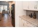 Modern kitchen with sleek black appliances, white cabinets, and stone countertops at 5332 Pembrey Dr, Denver, NC 28037