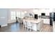 Bright, open kitchen with white cabinetry, stainless steel appliances, and granite countertops at 5332 Pembrey Dr, Denver, NC 28037