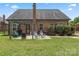 Brick home featuring a backyard patio with pergola, outdoor seating, and a well-manicured lawn at 5379 Roberta Meadows Ct, Concord, NC 28027