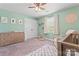 Comfortable bedroom with pale green walls, wood dresser, and playful decoration; perfect for relaxing and unwinding at 5379 Roberta Meadows Ct, Concord, NC 28027