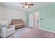 Cozy Bedroom with a ceiling fan, plush chair, patterned rug, and playful paw print wallpaper at 5379 Roberta Meadows Ct, Concord, NC 28027