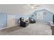Cozy bonus room with sloping ceilings, ceiling fan, carpeted floor, and comfortable leather recliners at 5379 Roberta Meadows Ct, Concord, NC 28027