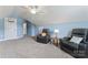 Relaxing bonus room with sloping ceilings, ceiling fan, carpeted floor, and comfortable leather chairs at 5379 Roberta Meadows Ct, Concord, NC 28027