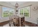 Bright dining area features dual windows and a stylish wine rack built into the base of the table at 5379 Roberta Meadows Ct, Concord, NC 28027