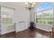 Inviting dining room with hardwood floors, large windows, and a charming sideboard at 5379 Roberta Meadows Ct, Concord, NC 28027