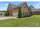 View of the house, showcasing the attached garage and well-maintained backyard at 5379 Roberta Meadows Ct, Concord, NC 28027