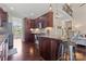 Modern kitchen with dark wood cabinets, granite countertops, and stainless steel appliances at 5379 Roberta Meadows Ct, Concord, NC 28027