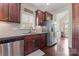 Well-appointed kitchen featuring stainless steel appliances, granite countertops, and tile backsplash at 5379 Roberta Meadows Ct, Concord, NC 28027