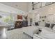 Open-concept living room with hardwood floors, high ceilings, and abundant natural light at 5379 Roberta Meadows Ct, Concord, NC 28027