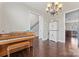 Elegant living room with a piano and staircase at 5379 Roberta Meadows Ct, Concord, NC 28027