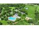Aerial view of community amenities including a pool, clubhouse, tennis courts, playground, green space, and parking at 6006 Casswell Cir, Matthews, NC 28104