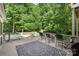 Inviting back deck featuring a patterned rug, outdoor seating, a grill and a view of the private backyard at 6006 Casswell Cir, Matthews, NC 28104