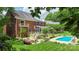 Spacious backyard featuring an in-ground pool, fire pit, deck, screened porch, and meticulously maintained landscaping at 6006 Casswell Cir, Matthews, NC 28104