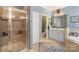 Modern bathroom with a glass-enclosed shower, double sinks, and a separate toilet area at 6006 Casswell Cir, Matthews, NC 28104