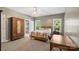Comfortable bedroom with natural light, a large wardrobe, and ensuite bathroom at 6006 Casswell Cir, Matthews, NC 28104