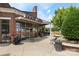 Commercial building featuring brick facade, inviting entrance, and outdoor seating area at 6006 Casswell Cir, Matthews, NC 28104