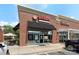 Commercial building featuring a vibrant red brick facade with glass storefront and ample parking at 6006 Casswell Cir, Matthews, NC 28104