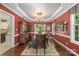 Formal dining room with dark wood floors, decorative trim, and ample natural light from a large window at 6006 Casswell Cir, Matthews, NC 28104