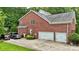 Brick home featuring a two-car garage, driveway, and backyard with a basketball hoop for outdoor enjoyment at 6006 Casswell Cir, Matthews, NC 28104