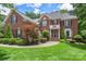 Charming brick home with well-maintained landscaping, black shutters, and a welcoming front entrance at 6006 Casswell Cir, Matthews, NC 28104