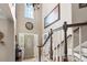 Grand foyer with soaring ceilings, a chandelier, staircase with wood banister, and a large front door at 6006 Casswell Cir, Matthews, NC 28104