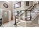 Stunning foyer featuring a staircase, high ceilings, decorative accents, and a view of the front entrance at 6006 Casswell Cir, Matthews, NC 28104