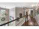 Bright hallway with hardwood floors, white trim, decorative lighting and an art-filled gallery wall at 6006 Casswell Cir, Matthews, NC 28104
