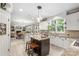 Bright and airy kitchen with a large island, white cabinetry, and views into the adjoining living spaces at 6006 Casswell Cir, Matthews, NC 28104