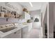 Well-organized laundry room features front loading machines, cabinet and door leading to the backyard at 6006 Casswell Cir, Matthews, NC 28104