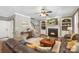 Cozy living room with a fireplace, plush seating, and a staircase leading to the upper level at 6006 Casswell Cir, Matthews, NC 28104