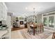 Open-concept living room with dining area, fireplace, and large windows offering ample natural light at 6006 Casswell Cir, Matthews, NC 28104