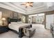Well-lit main bedroom features a tray ceiling, fan, and a seating area with a desk at 6006 Casswell Cir, Matthews, NC 28104