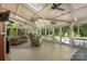Spacious screened-in porch with comfortable seating, ceiling fans and a clear view of the backyard at 6006 Casswell Cir, Matthews, NC 28104