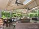 Inviting sunroom featuring skylights, ceiling fans, comfortable seating, and views of the pool and lush backyard at 6006 Casswell Cir, Matthews, NC 28104