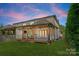 Beautiful backyard featuring covered patio with outdoor fireplace and ample green space at 6242 Creola Rd, Charlotte, NC 28270