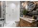 Stylish powder room featuring bold wallpaper, marble countertop vanity, and a modern glass-enclosed shower at 6242 Creola Rd, Charlotte, NC 28270