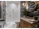 Modern bathroom featuring a glass shower, unique wallpaper, and a stylish vanity at 6242 Creola Rd, Charlotte, NC 28270
