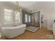Bright bathroom with a freestanding tub, walk-in shower, and modern fixtures at 6242 Creola Rd, Charlotte, NC 28270