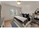 Bright bedroom featuring modern decor, patterned rugs, and large windows with plantation shutters at 6242 Creola Rd, Charlotte, NC 28270