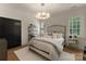 Bright bedroom with neutral decor, modern chandelier, and plantation shutters at 6242 Creola Rd, Charlotte, NC 28270
