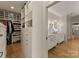 Well-organized closet adjacent to bathroom featuring custom shelving and storage at 6242 Creola Rd, Charlotte, NC 28270