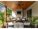 Covered patio featuring a fireplace, ceiling fan, and comfortable seating area with stylish decor at 6242 Creola Rd, Charlotte, NC 28270